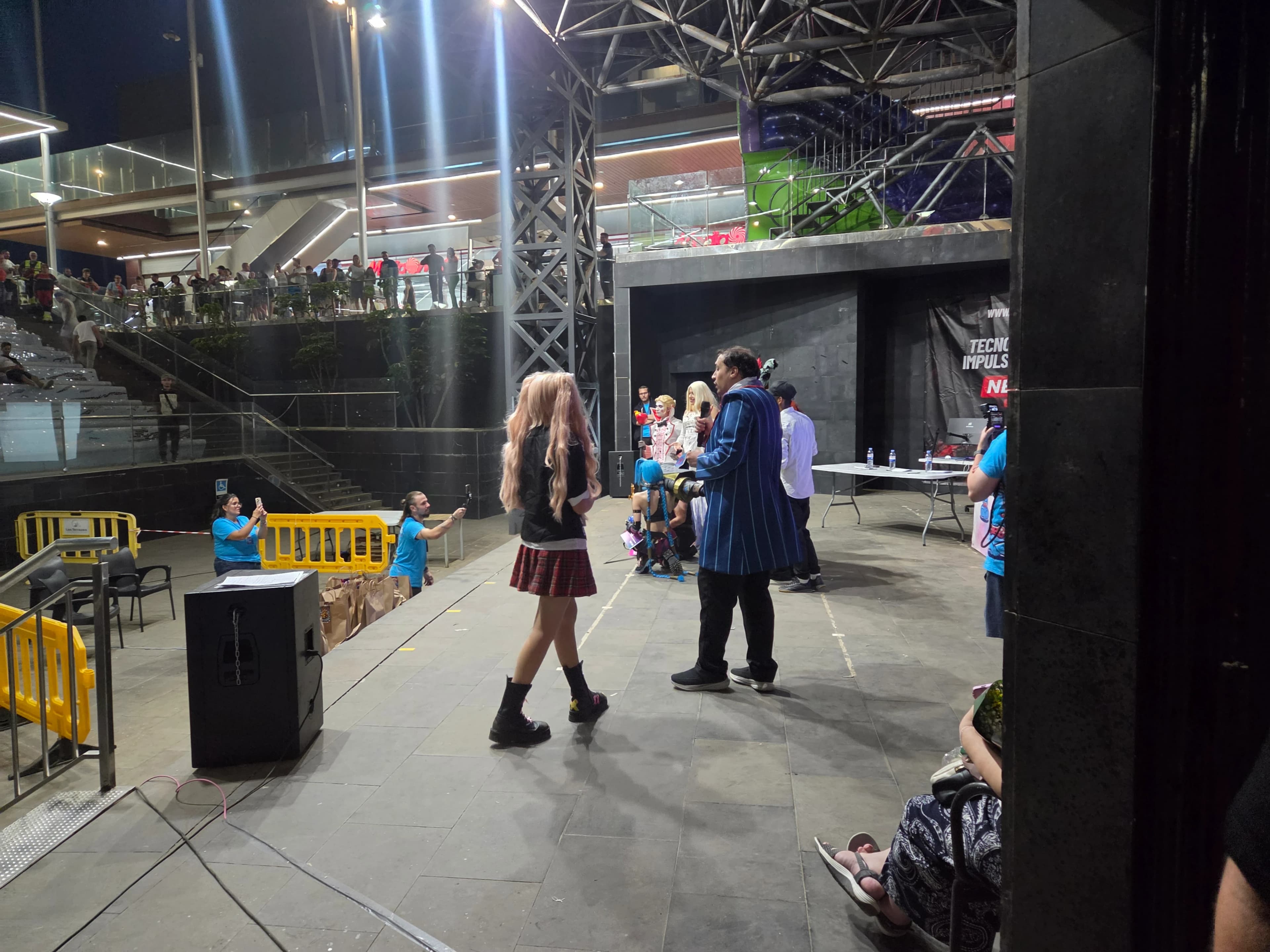 Quasar Store and Next Level Origins handing out giveaway prizes to event attendees