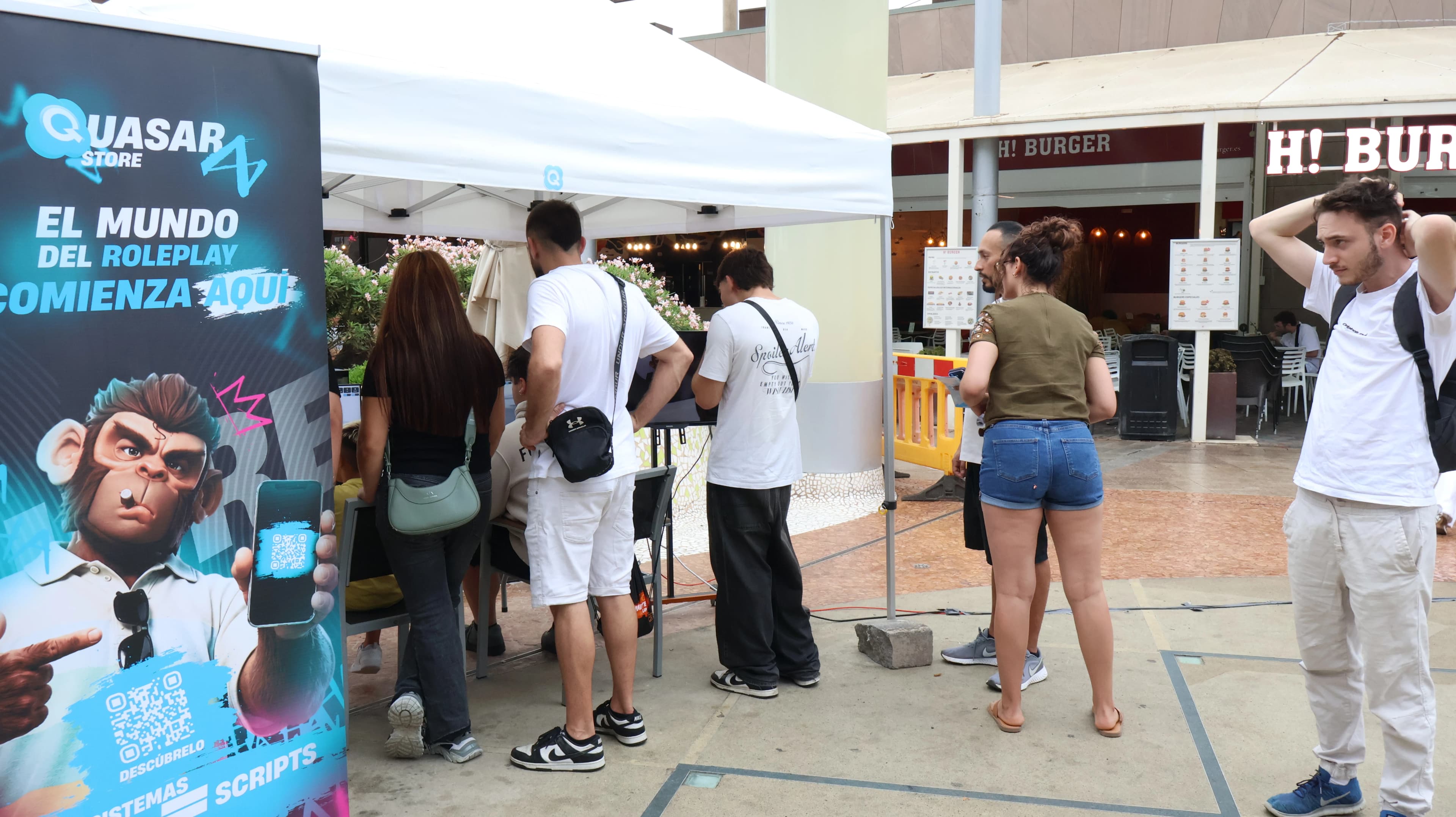 Quasar Store customers chatting with the team at the Next Level Origins booth