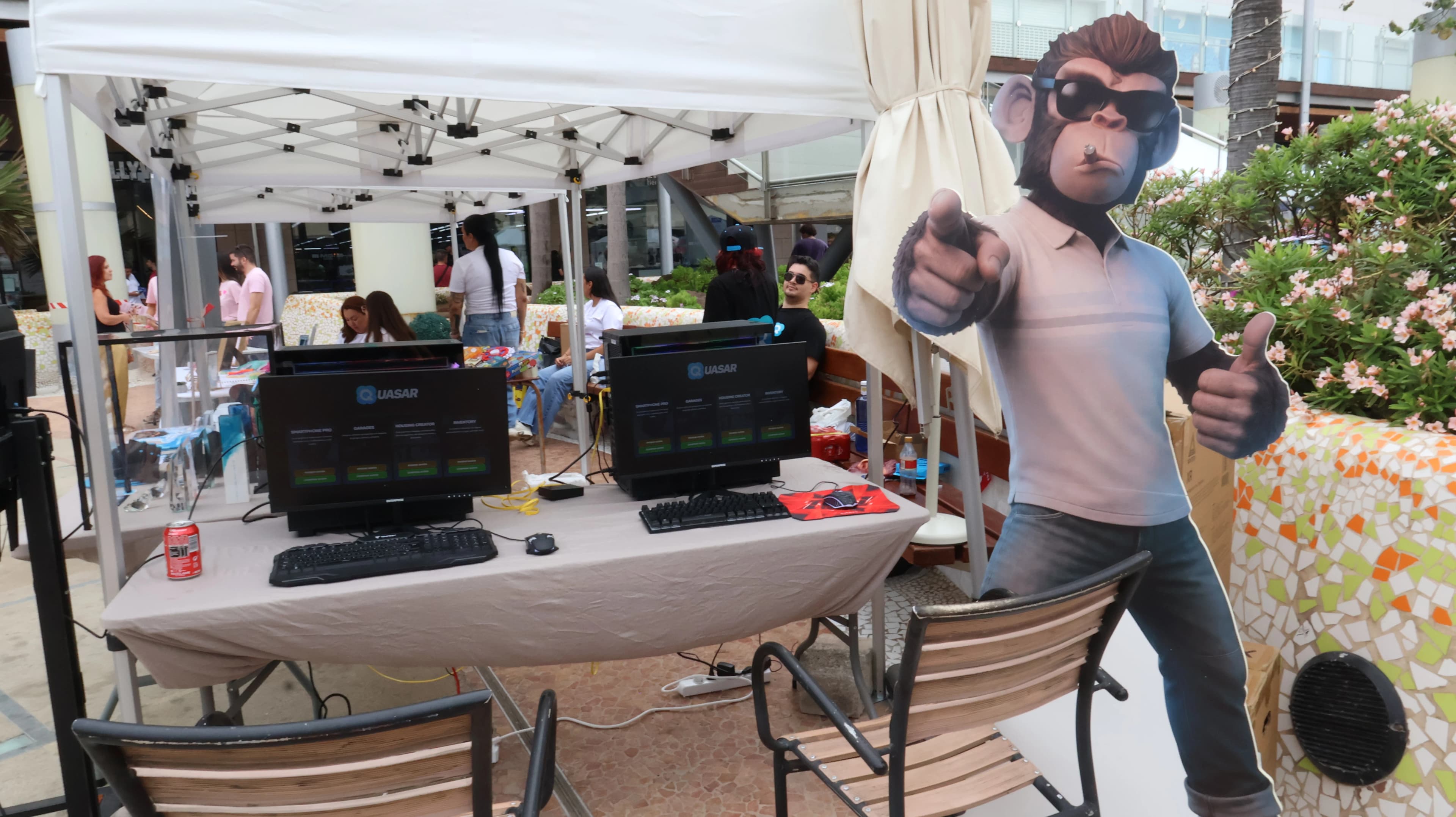 Visitors taking photos with the giant monkey, the Quasar Store mascot, at Next Level Origins