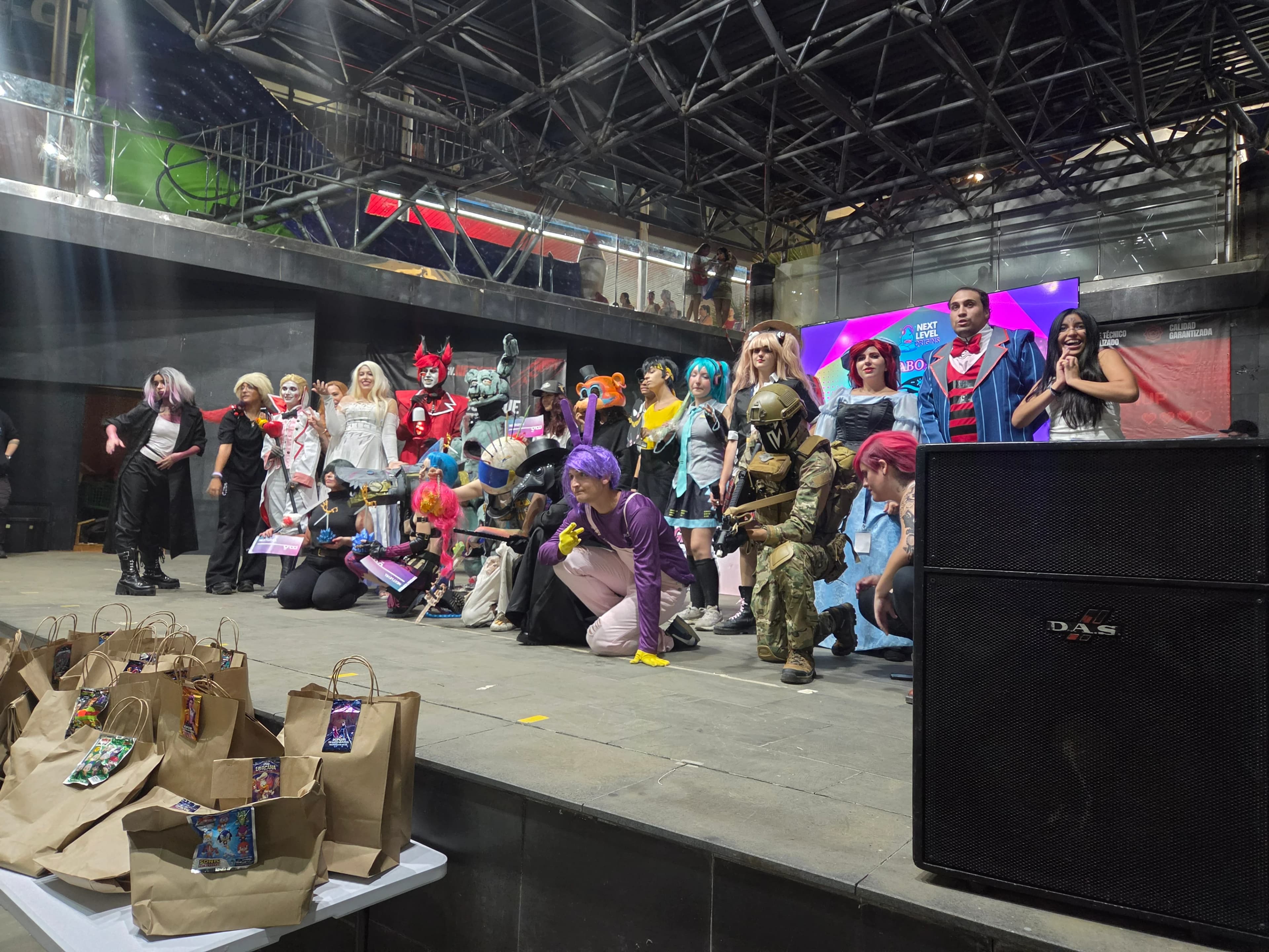 Cosplayers at the Next Level Origins event posing with the Quasar Store team